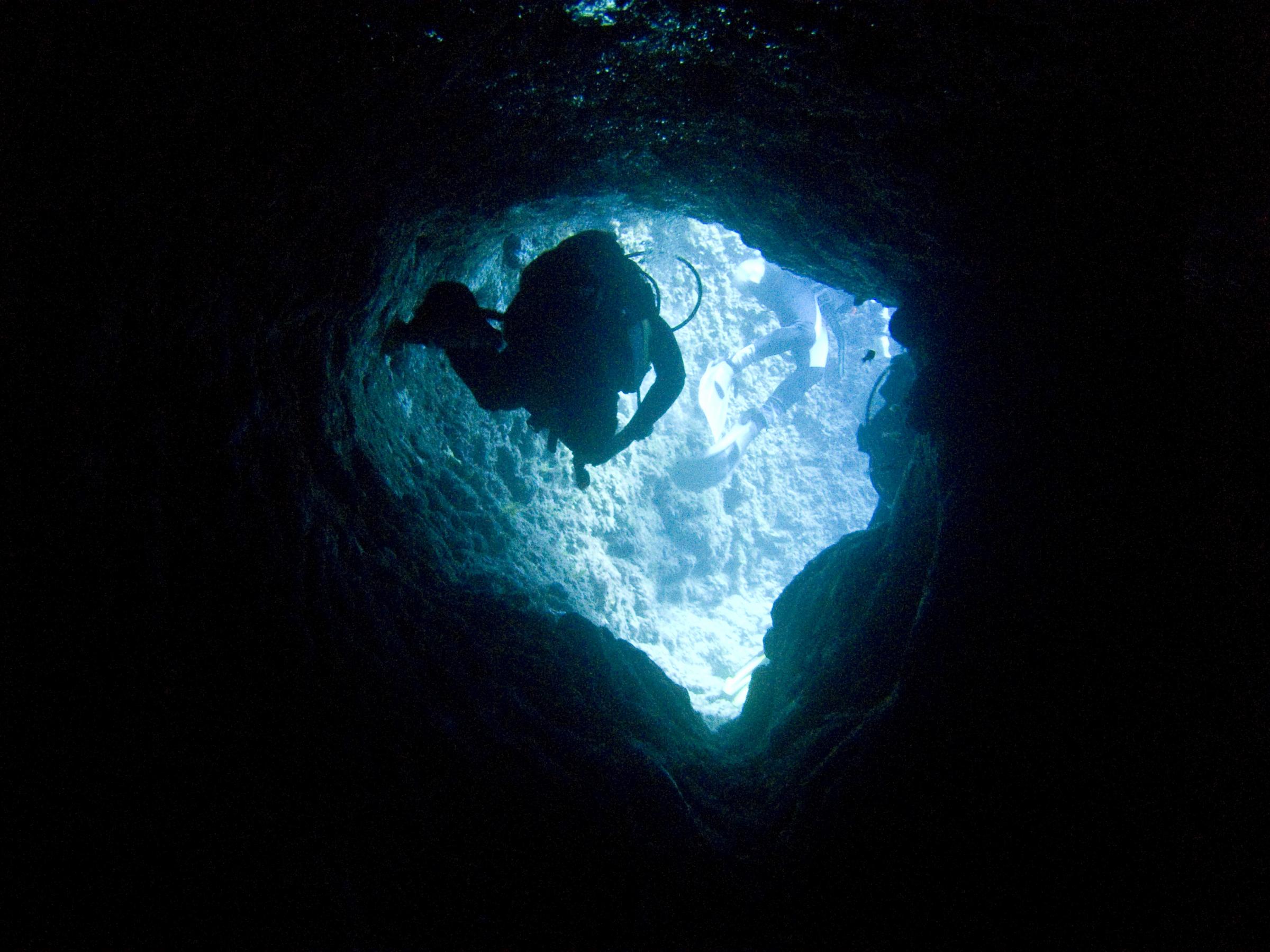 Divers in one of the tunnels on the reef